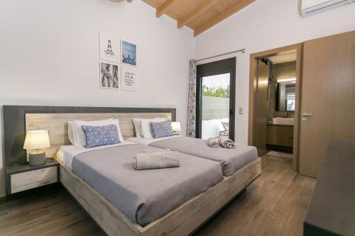 a bedroom with a large bed and a bathroom at Villa Stavelia in Gouves