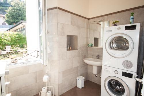 a bathroom with a washing machine and a sink at Casa Julia - Menaggio by LoveComo in Menaggio