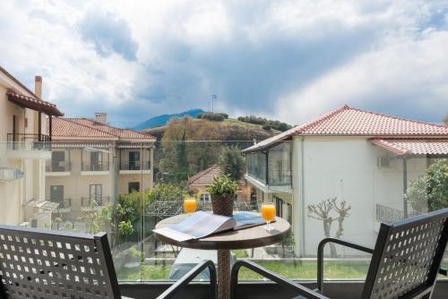 a balcony with a table and chairs and a view at Tsikeli Boutique Hotel Meteora - Adults Friendly in Kalabaka