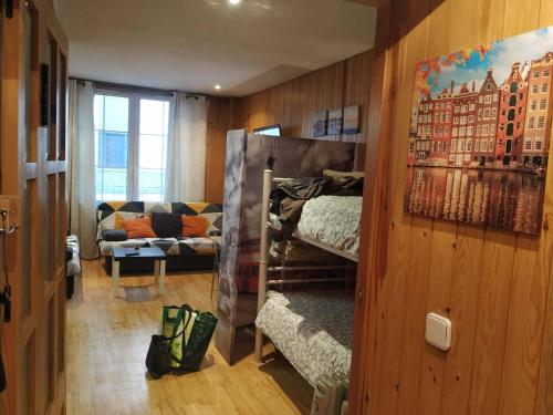a room with two bunk beds and a couch at GRAN ESTUDiO MARIBEL in Sierra Nevada