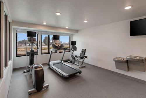 a gym with cardio equipment and a flat screen tv at WoodSpring Suites Tri-Cities Richland in Richland