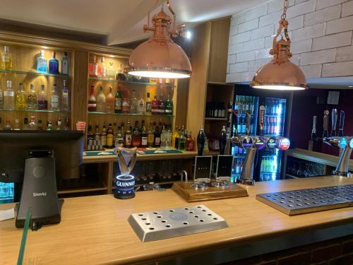 a bar with a trophy on top of a counter at The White Horse in Cranswick