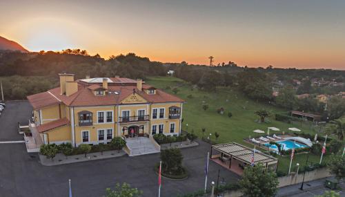 an aerial view of a large house with a pool at Hotel Finca La Mansión in Llanes