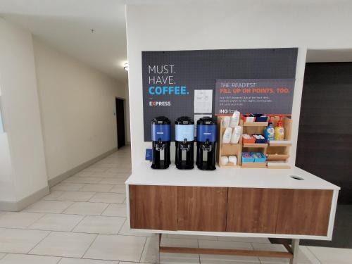 a coffee counter in a room with bottles on it at Holiday Inn Express Hotel & Suites Vidor South by IHG in Vidor