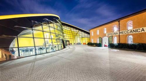 a large building with a large glass facade at Hotel Stella in Modena