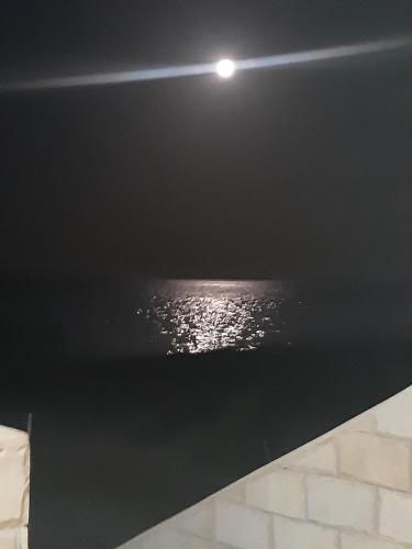 a light on the ceiling of a room with water at вилла Coral Paradise in Safaga 
