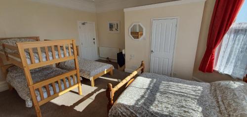 a bedroom with two bunk beds and a ladder at sunnylodge in Folkestone