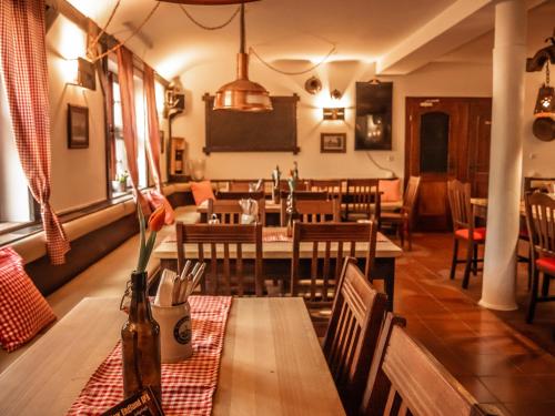 un ristorante con tavolo e sedie e una sala da pranzo di Waldhotel Zollhaus a Norimberga