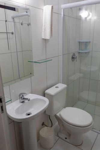 a bathroom with a toilet and a sink and a shower at Hotel Vitoria - Itajaí in Itajaí