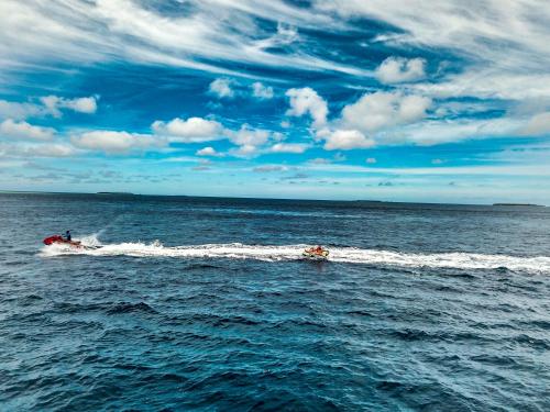 a speed boat in the water on the ocean at Sabba Beach Suite , Fodhdhoo - Maldives in Velidhoo