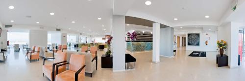 a lobby of a store with chairs and tables at Hotel Mar e Sol & Spa in São Pedro de Moel
