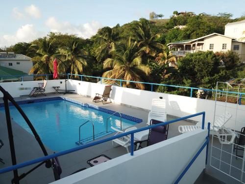 a swimming pool on the deck of a cruise ship at Blue Star Apartments & Hotel in Lance aux Épines