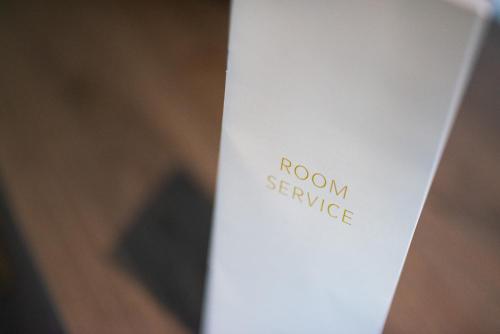 a white book with the words room service on it at Mercure Blackburn Dunkenhalgh Hotel & Spa in Blackburn