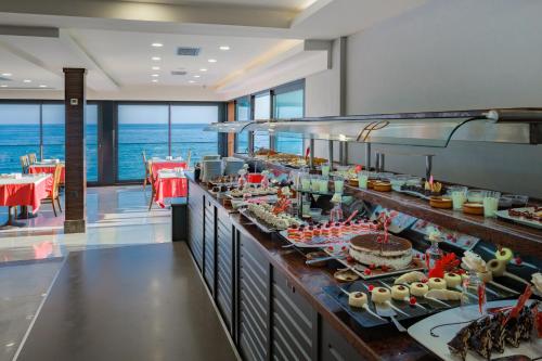 a buffet line with food on display in a restaurant at Panorama Hotel - All Inclusive in Alanya