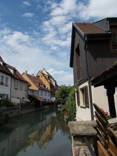 a river in a town with houses and buildings at Petite Venise in Colmar