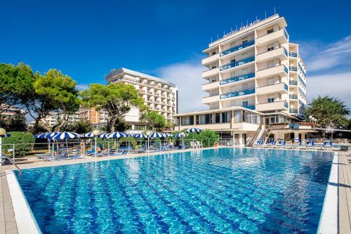 a large swimming pool in front of a building at Hotel Danieli in Bibione