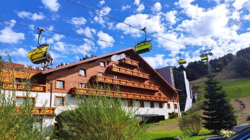 a ski lift in front of a building at Hotel Meta Resort & Vine SPA in Szczyrk