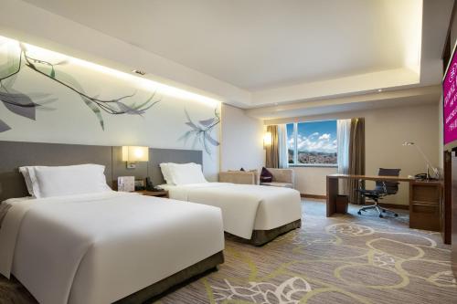 a hotel room with two beds and a desk at Crowne Plaza Guangzhou City Centre by IHG - Free shuttle between hotel and Exhibition Center during Canton Fair & Exhibitor registration Counter in Guangzhou