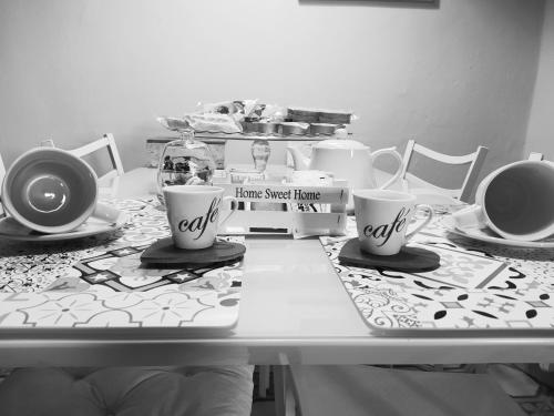 a table with three coffee cups on top of it at Casa vacanze San Giovanni nei Sassi in Matera