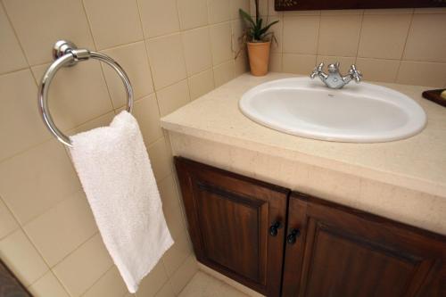 a bathroom with a sink and a white towel at Solar de Chacim - Turismo de Habitação in Chacim