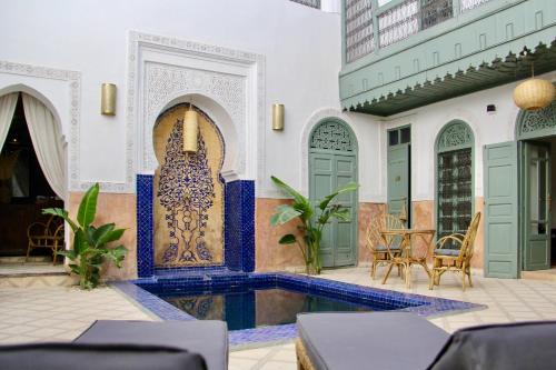 a courtyard with a swimming pool in a house at Riad Sierra in Marrakesh