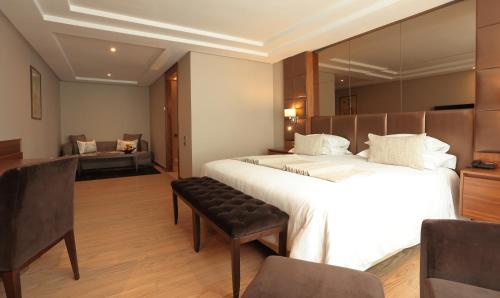 a hotel room with a large bed and a couch at Le Palace d'Anfa in Casablanca