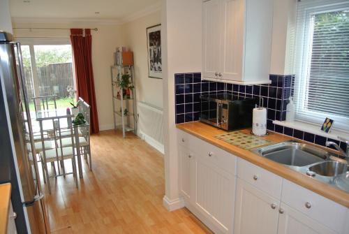 a kitchen with a sink and a counter top at Bramley Cottage in Sandown