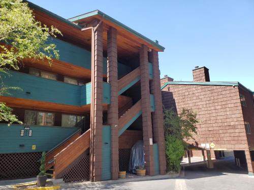 a building with a wooden balcony on the side of it at GetAways at Snow Lake Lodge in Big Bear Lake