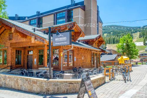 a restaurant with tables and chairs in front of a building at Anaconda 102 in Copper Mountain