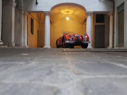 a red car parked in front of a building at L'Altana City House in Brescia
