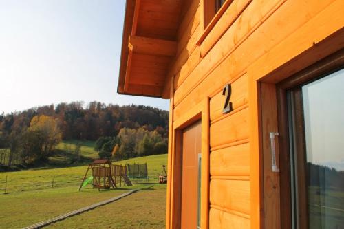 a building with a window and a view of a field at Domki pod Bukowym lasem in Wańkowa