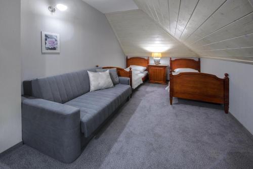 a living room with a couch and a bed at Hotel Zalesie in Bochnia