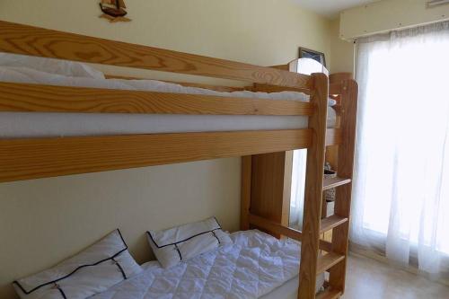 1 Schlafzimmer mit 2 Etagenbetten und einem Fenster in der Unterkunft La Corniche in Agon Coutainville