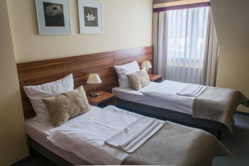 Кровать или кровати в номере Zajazd u Dziadka