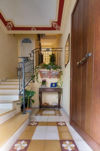a hallway with a door and stairs with plants at Casa Manzella in Terrasini