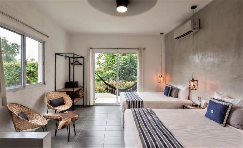 Postel nebo postele na pokoji v ubytování Hotel Aires Bacalar