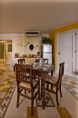 a kitchen with a table and chairs and a refrigerator at Casa Manzella in Terrasini