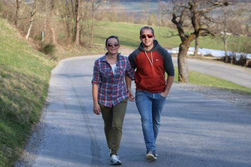 a man and a woman walking down a road at Restaurant - Café - Pension HASSLER in Berg im Drautal