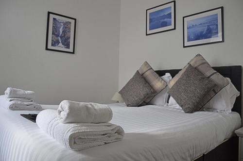 a white bed with towels on top of it at The Punchbowl Inn in Askham