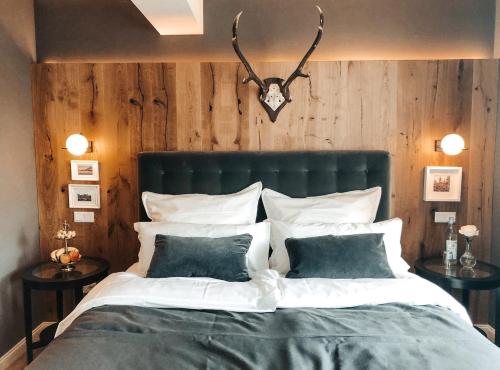 a bedroom with a large bed with two tables at Suite Living Boardinghouse Apartments in Gießen