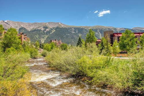 a trail through a forest with mountains in the background at Summit House East in Copper Mountain
