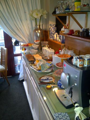 a kitchen with a counter with food on it at Mulligans Guest Lodge in Hermanus