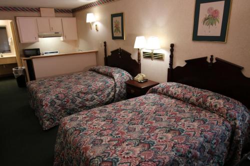 a hotel room with two beds and a telephone at Executive Inn Kershaw in Kershaw