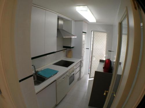 a white kitchen with a sink and a stove at Precioso Apartamento Puerto Banus Marbella in Marbella