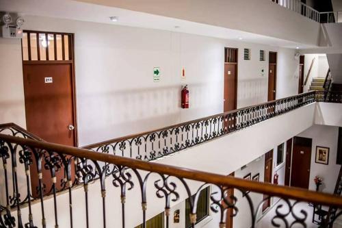 a stairway with a bunch of doors in a building at Hotel Estancia Real in Piura