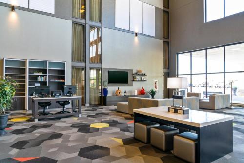 a living room with a couch and a table at Holiday Inn Morgantown - Reading Area by IHG in Morgantown