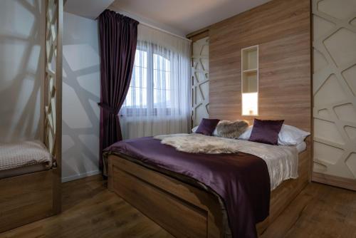 a bedroom with a bed and a window at GOLDENapartment in Veľká Lomnica