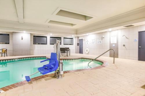 a swimming pool with a slide in a building at Holiday Inn Express & Suites Longview North by IHG in Longview