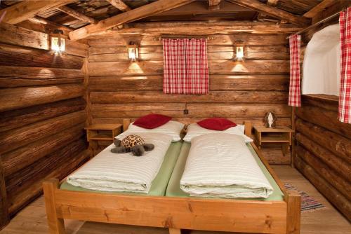 een kamer met 2 bedden in een blokhut bij Appartement Rossalm mit Sauna in Alpbach