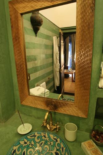 a bathroom with a sink and a mirror at Riad Terra Bahia in Marrakech